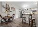Bright kitchen with breakfast bar, stainless steel appliances, and wood-look laminate flooring at 6324 Amberly Rd, Rex, GA 30273