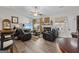 Cozy living room with hardwood floors, a ceiling fan, and a fireplace, creating a warm and inviting atmosphere at 6324 Amberly Rd, Rex, GA 30273