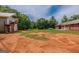 Large backyard presenting the home's exterior with adjacent outbuilding and expansive grounds, blending nature and residence at 1170 Peeksville Rd, Locust Grove, GA 30248