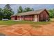 Spacious backyard highlighting the house and its outdoor potential with ample land and a quaint rear entrance at 1170 Peeksville Rd, Locust Grove, GA 30248