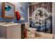 Blue toned bathroom featuring a toilet, sink, vanity, framed painting and a playful dolphin shower curtain at 1170 Peeksville Rd, Locust Grove, GA 30248