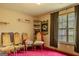 Cozy bedroom featuring a window with curtains, wood chairs, and a bright pink carpet at 1170 Peeksville Rd, Locust Grove, GA 30248