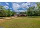 Exterior view of a red house with an attached two-car garage at 1170 Peeksville Rd, Locust Grove, GA 30248