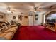 Open living room featuring a ceiling fan and access to white exterior door at 1170 Peeksville Rd, Locust Grove, GA 30248