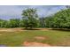 Open grassy area with trees and evidence of use at 1170 Peeksville Rd, Locust Grove, GA 30248