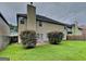 View of the home's backyard featuring a large lawn and manicured bushes at 4140 Butternut Pl, South Fulton, GA 30349