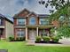 Charming two-story brick home with a covered front porch and well-maintained landscaping at 4140 Butternut Pl, South Fulton, GA 30349