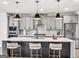 Modern kitchen with gray cabinets, stainless steel appliances, and a large island with pendant lighting at 209 Langshire Dr, Mcdonough, GA 30253