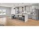 Bright, modern kitchen with a large marble island, stainless appliances, and sleek lighting at 209 Langshire Dr, Mcdonough, GA 30253