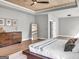 Inviting main bedroom with a wood-paneled ceiling, hardwood floors, and comfortable furnishings at 209 Langshire Dr, Mcdonough, GA 30253