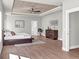 Bright main bedroom featuring a wood-paneled ceiling, hardwood floors, and ample closet space at 209 Langshire Dr, Mcdonough, GA 30253