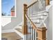 Stylish staircase with wooden handrails and black metal spindles, brightened by a nearby window at 209 Langshire Dr, Mcdonough, GA 30253