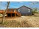 Exterior backyard view featuring a wood deck and grey siding with trimmed shrubbery at 79 Turner Dr, Mcdonough, GA 30252