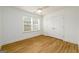 Bright bedroom with hardwood floors, ceiling fan, double windows, and closet at 79 Turner Dr, Mcdonough, GA 30252