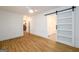 Bright bedroom featuring hardwood floors and a sliding barn door with ensuite bathroom at 79 Turner Dr, Mcdonough, GA 30252