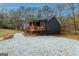 Beautiful exterior view of a home with a wooden porch and surrounding gravel landscaping near a pond at 79 Turner Dr, Mcdonough, GA 30252