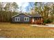 Charming gray home featuring a cozy front porch, manicured landscaping, and welcoming curb appeal at 79 Turner Dr, Mcdonough, GA 30252