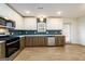 Open kitchen includes stainless appliances, modern backsplash, white countertops, and ample cabinet space at 79 Turner Dr, Mcdonough, GA 30252
