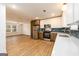 Open concept kitchen with stainless steel appliances flowing to the living area filled with natural light at 79 Turner Dr, Mcdonough, GA 30252