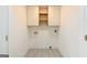 Laundry room with tile flooring, floating cabinets, and modern design at 79 Turner Dr, Mcdonough, GA 30252