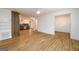 Open concept living space featuring modern wood flooring flowing into the kitchen at 79 Turner Dr, Mcdonough, GA 30252