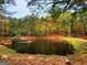 Scenic pond view with wooden dock and surrounding fall foliage, offering a tranquil natural setting at 79 Turner Dr, Mcdonough, GA 30252