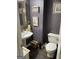 Charming half bathroom featuring unique wallpaper and an elegant pedestal sink at 171 Galesburg Dr, Lawrenceville, GA 30044