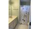 Bathroom featuring double sinks, a toilet, and a bathtub with shower and floral shower curtain at 171 Galesburg Dr, Lawrenceville, GA 30044
