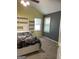 Bedroom with built in shelves and two windows with carpeted flooring at 171 Galesburg Dr, Lawrenceville, GA 30044
