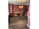 Formal dining room featuring dark laminate wood floors, a chandelier, and red walls at 171 Galesburg Dr, Lawrenceville, GA 30044