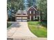 Charming two-story brick home with a two-car garage, dormer windows, and a well-maintained lawn on a sunny day at 171 Galesburg Dr, Lawrenceville, GA 30044