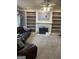 Open living room features a fireplace, built-in shelving, and neutral carpet at 171 Galesburg Dr, Lawrenceville, GA 30044