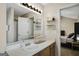 Bright bathroom featuring vanity with white countertop, modern lighting, and an en suite bedroom at 351 Autumn Lake Dr, Mcdonough, GA 30253
