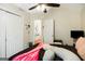 Comfortable bedroom features a ceiling fan, a pink throw blanket, and a view of an en suite bathroom at 351 Autumn Lake Dr, Mcdonough, GA 30253