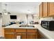 Bright kitchen featuring double sinks, white countertops, and an open view of the living room at 351 Autumn Lake Dr, Mcdonough, GA 30253