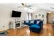 Cozy living room featuring hardwood floors, a ceiling fan and a wall-mounted TV at 351 Autumn Lake Dr, Mcdonough, GA 30253