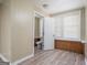 Bedroom featuring vinyl flooring, light walls, and a partial brick wall beneath the window at 1774 Campbellton Rd, Atlanta, GA 30311