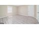 Bedroom featuring neutral walls, new floors and door to hall at 1774 Campbellton Rd, Atlanta, GA 30311