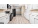 Spacious kitchen featuring appliances, white cabinetry, and hardwood flooring at 1774 Campbellton Rd, Atlanta, GA 30311