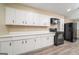 Kitchen with white cabinets, black appliances, and wood-style flooring at 1774 Campbellton Rd, Atlanta, GA 30311