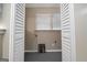 Laundry room behind louvered doors with view of window and laundry connections at 1774 Campbellton Rd, Atlanta, GA 30311