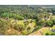 A spacious property boasts mature trees, multiple residences, a pool, and long driveways at 550 Davis Rd, Fayetteville, GA 30215