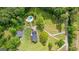 A sprawling estate with a pristine pool area, lush landscaping, and a winding driveway showcases luxury living at 550 Davis Rd, Fayetteville, GA 30215