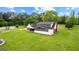 Spacious backyard featuring a red-brick home with a sunroom and lush green lawn at 550 Davis Rd, Fayetteville, GA 30215