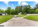 Spacious backyard with a shed and gazebo beyond a pool surrounded by a white fence at 550 Davis Rd, Fayetteville, GA 30215