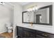 Stylish bathroom features a black vanity, gold fixtures, white countertop, and a large mirror at 550 Davis Rd, Fayetteville, GA 30215
