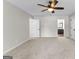 Bright bedroom with neutral carpet, ceiling fan, and an ensuite bathroom at 550 Davis Rd, Fayetteville, GA 30215