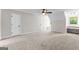 Spacious bedroom with neutral carpet, ceiling fan, and desk area beneath a bright window at 550 Davis Rd, Fayetteville, GA 30215