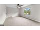 Large bedroom features plush carpeting, a ceiling fan, and a bright double window at 550 Davis Rd, Fayetteville, GA 30215