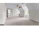 Large bonus room with carpet, neutral walls and ceiling fan, providing a versatile space for relaxation or entertainment at 550 Davis Rd, Fayetteville, GA 30215